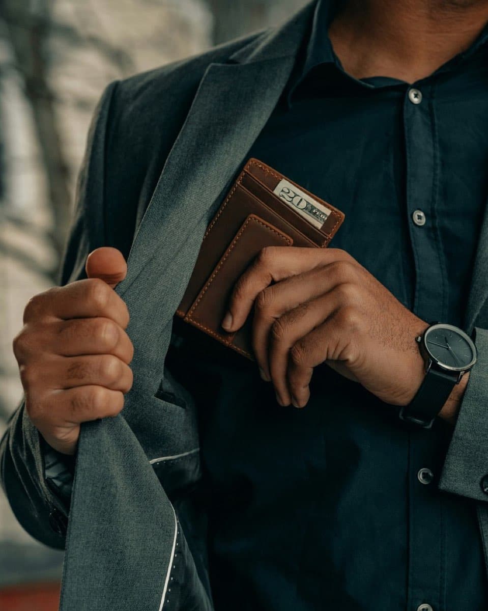 Man holding wallet and watch